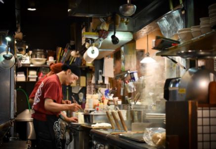 Japanese chef cooking ramen noodles at a ramen-ya in Japan