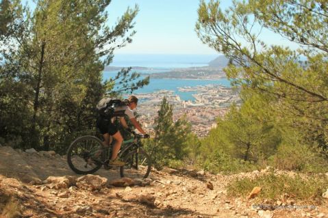 Mountain biking down the Mont Faron with a view on the bay of Toulon, France.