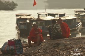 Monks waiting by the boat landing, Muang Khua, Laos