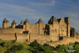 The medieval walled city of Carcassonne without people, on a hill, in the sun and with blue skies.