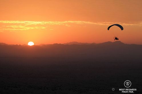 Paramotoring at sunrise over the desert of Dubai, UAE