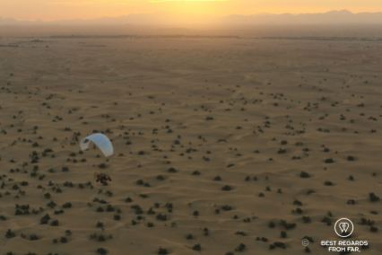 Paramotoring at sunrise over the desert of Dubai, UAE