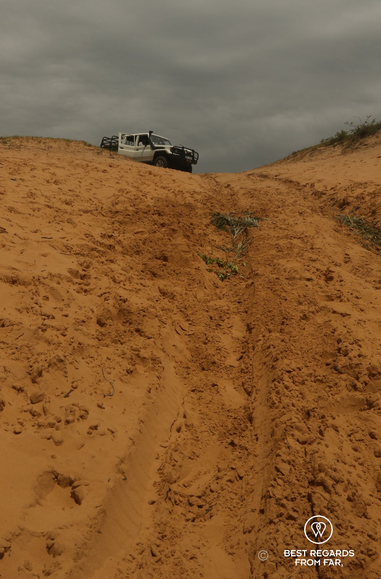 4x4 on top of a steep dune, Black Rock Beach, South Africa