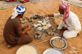 Gursh bread being baked in the desert, Oman