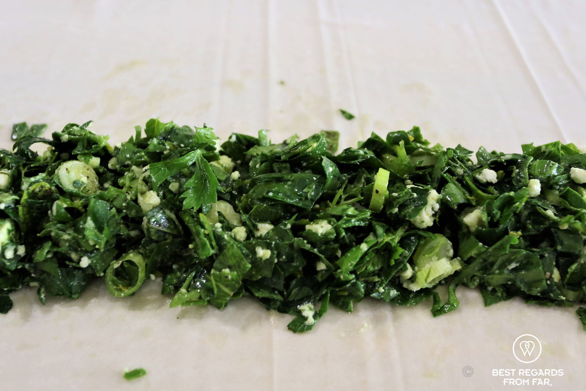 Finely chopped green herbs on a dough, The Greek Kitchen Athens, cooking class, Greece