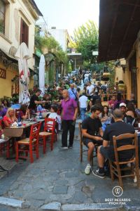 Busy street with people having drinks in Plaka, Athens, Greece.