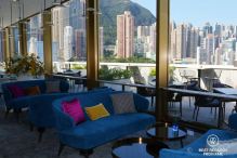 Stylish interior decoration of the Popinjays bar at the Murray Hotel, Hong Kong with Victoria Peak and high-rise buildings in the background