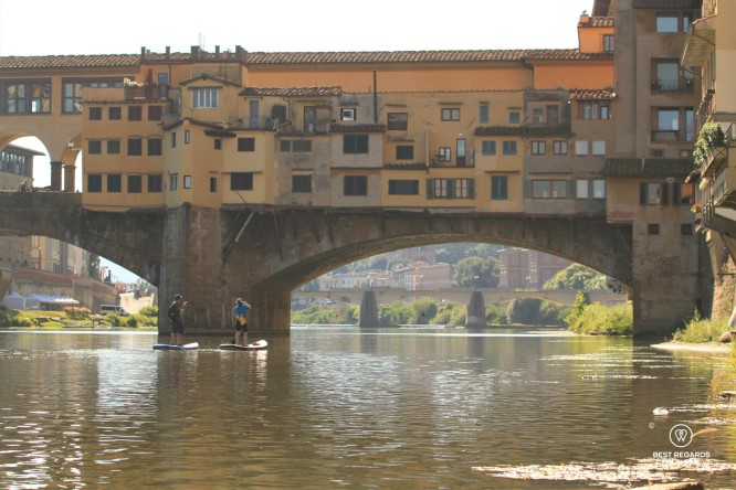 Stand up paddling the Arno River by the Ponte Vecchio in Florence, Italy.